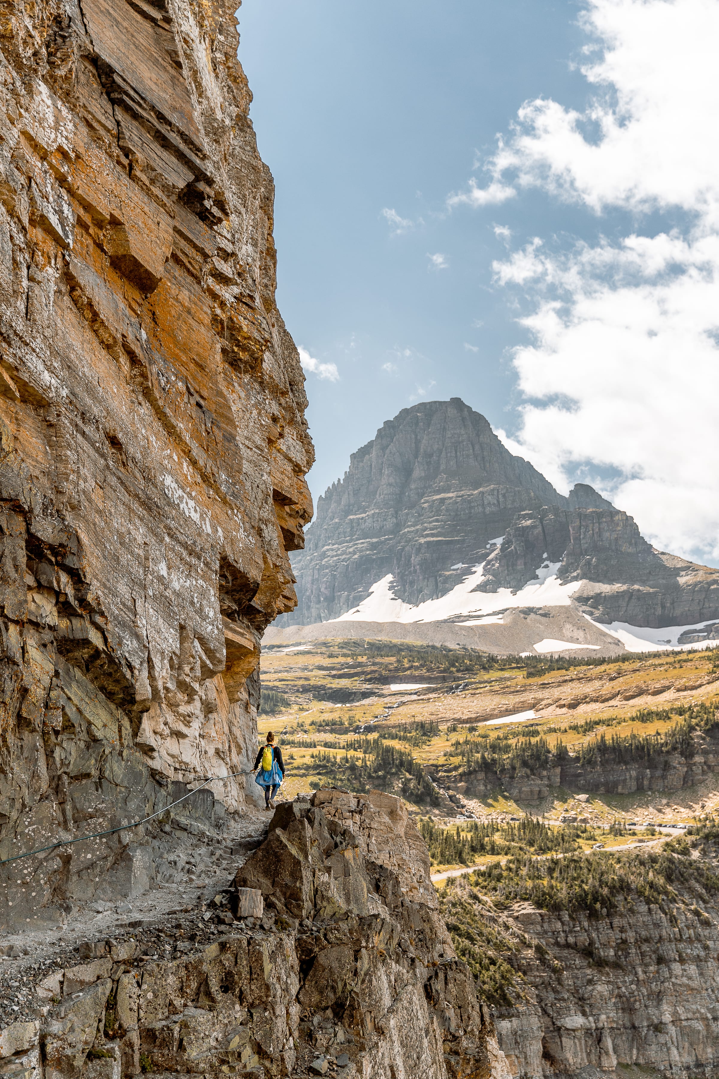Adventure — a hiker on a high cliff ledge